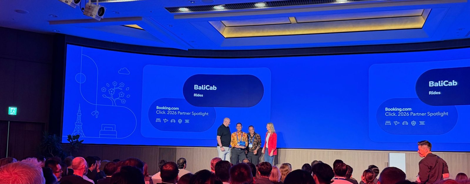 BaliCab team receiving the Booking.com Best Ground Transportation Partner Asia Pacific award on stage